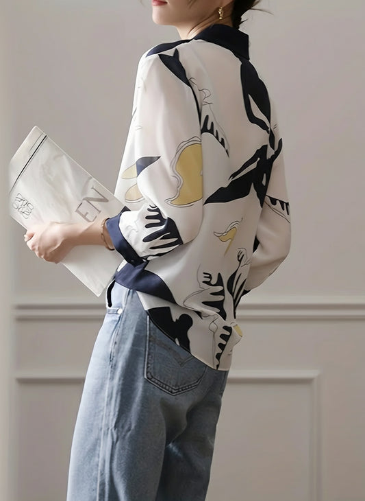 Person wearing a patterned shirt and holding a white bag with a logo.
