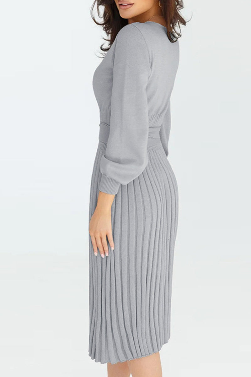 Woman wearing a gray ribbed dress on a white background