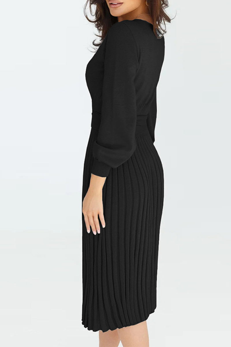 Woman wearing a black pleated dress on a white background
