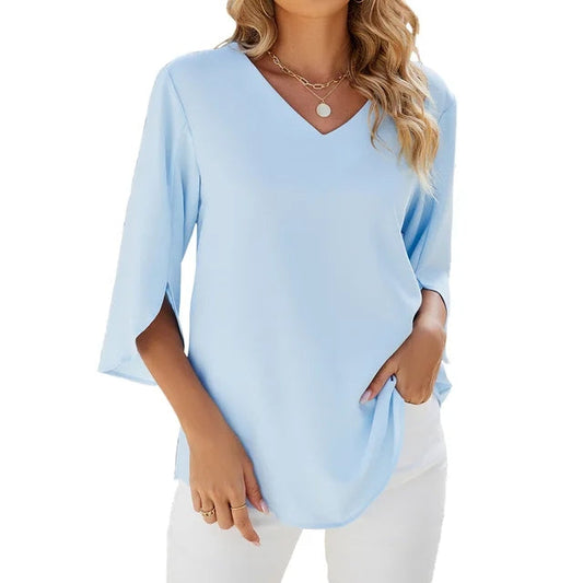 Light blue blouse worn by a person on a white background