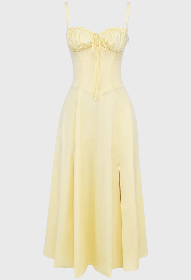 Yellow dress with thin straps on a light gray background