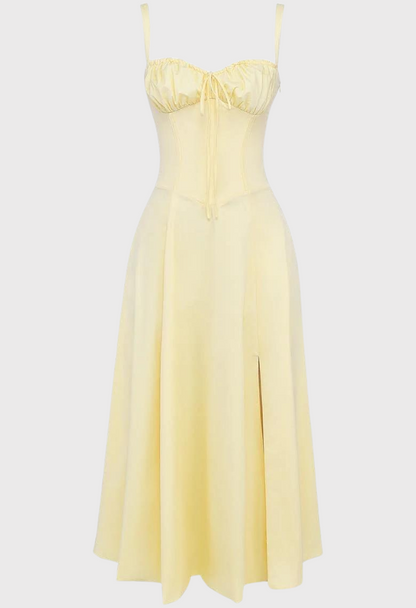 Yellow dress with thin straps on a light gray background