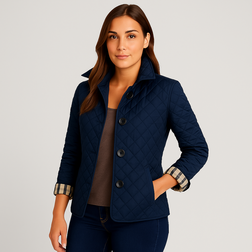 Woman wearing a navy quilted jacket on a gray background