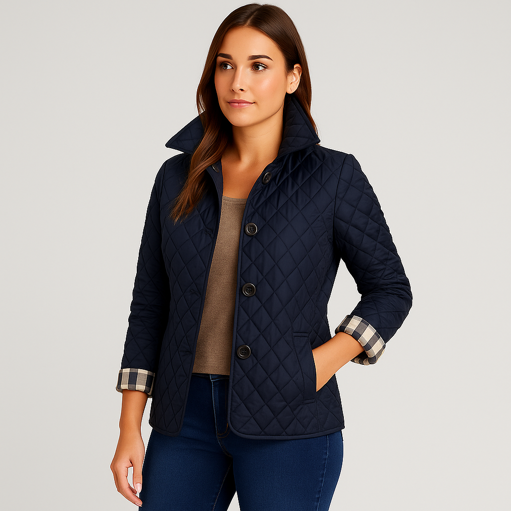 Woman wearing a navy quilted jacket on a light gray background